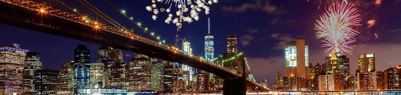 New York skyline and Brooklyn Bridge illuminated by fireworks